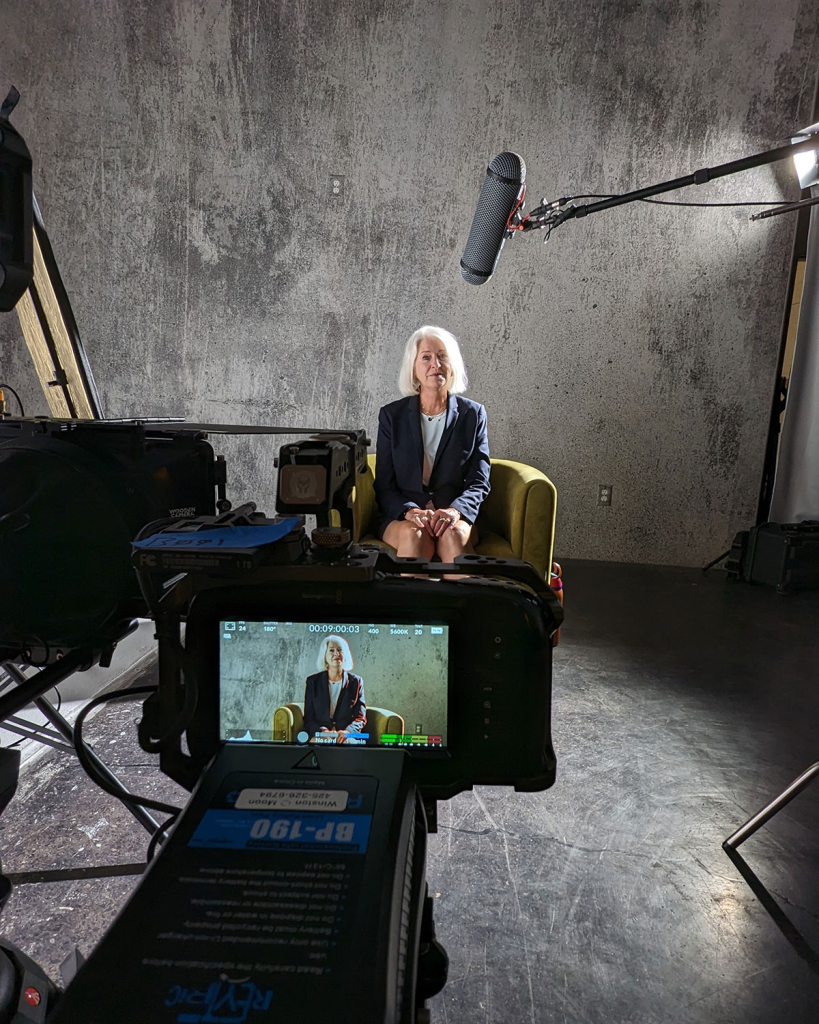 Behind the scenes in a film studio with a female subject in the background.